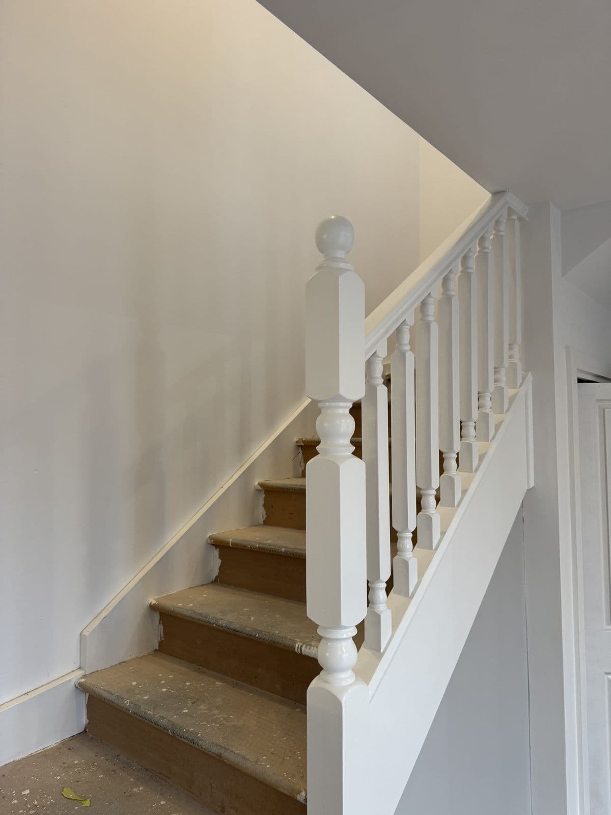 Staircase newel post and balusters painted white