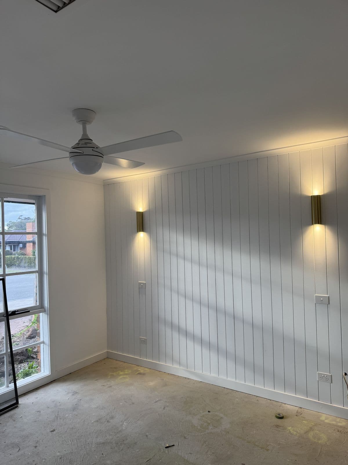 Bedroom with a white vertical-panel feature wall and white ceiling