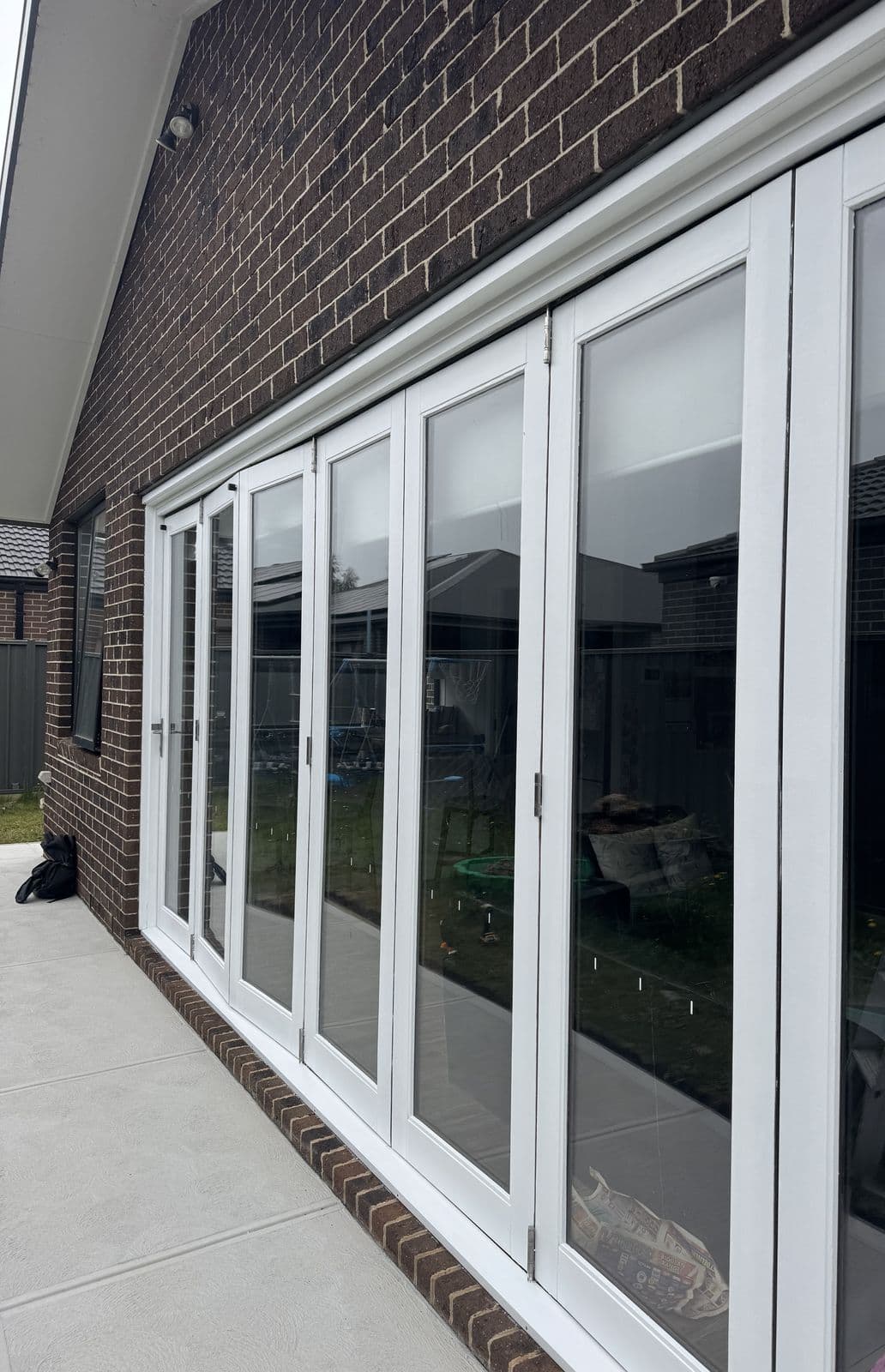 After: the same bifold doors painted white